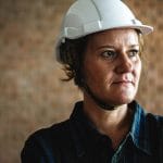 Woman constructor wearing hard helmet