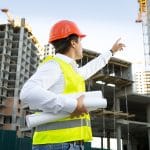 Site manager checking building site under construction